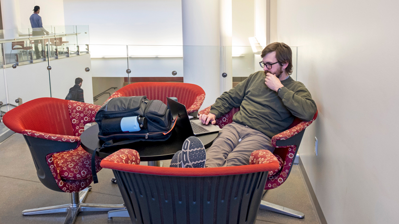 Ray Kannenberg, a first-year doctoral student pursuing his PhD in cellular biology, studies in the lobby of the Science Learning Building