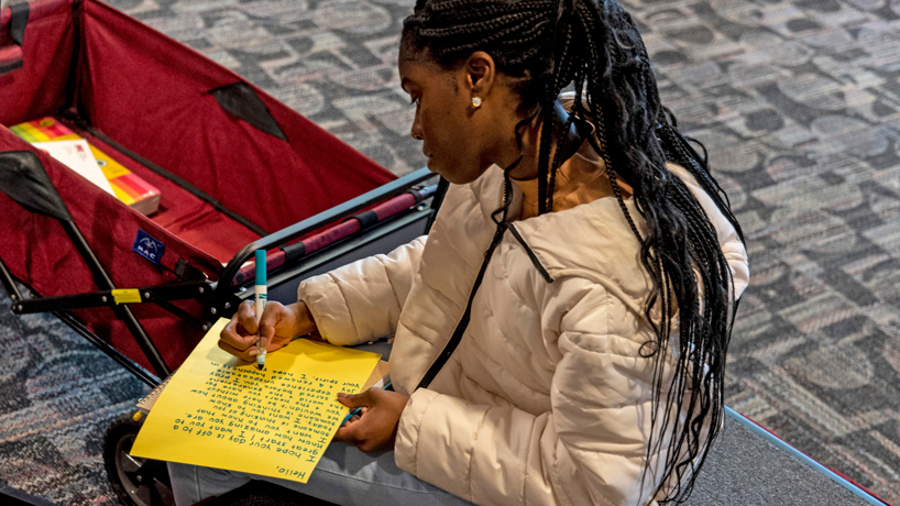 Jayla McDonald, a senior majoring in English and psychology, pens a letter to a senior citizen last Wednesday during a Martin Luther King Jr. Day of Service activity
