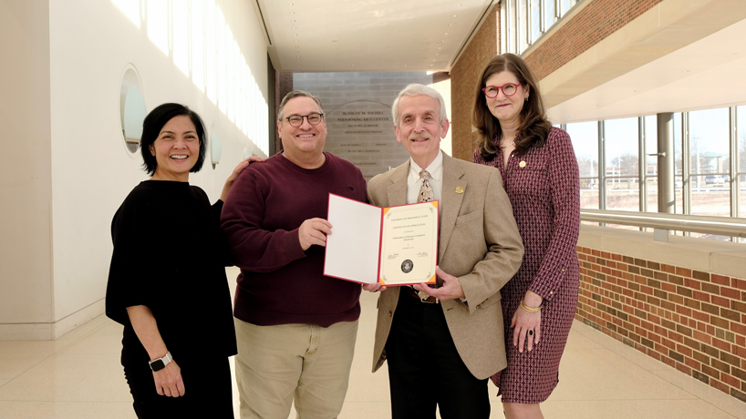 Professor Joan Mendoza (at left), chair of the Department of Music, joins Associate Professor and Director of Choral Studies Jim Henry and Senior Director of Development Deb Godwin in presenting a certificate of appreciation to alumnus Michael Rubin