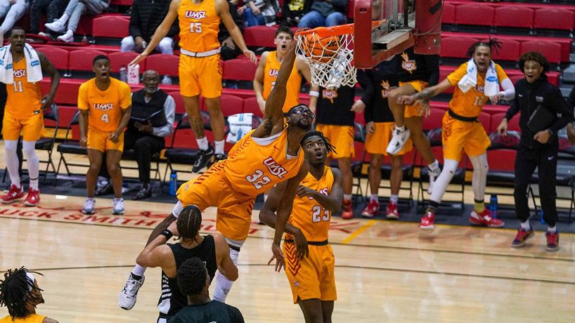 Victor Nwagbaraocha extends his right arm to finish a dunk over Wisconsin-Parkside's Jacksun Hamilton as his teammates celebrate in the background