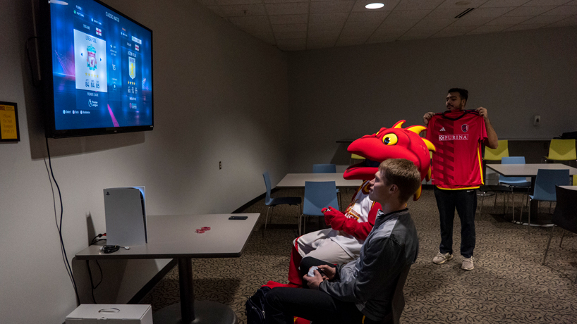 Louie sits down to play a game of FIFA against an UMSL students in the Millennium Student Center after an announcement that UMSL is launching an esports program beginning next fall