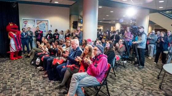 A large crowd applauds at the announcement of a new partnership between St. Louis CITY SC and UMSL