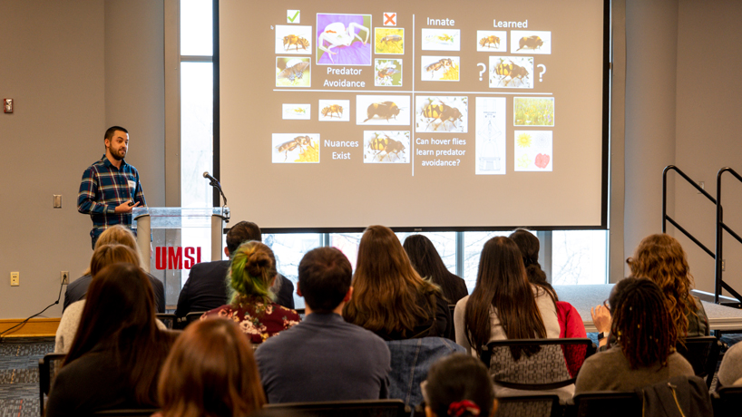 Biology PhD student George Todd delivers his presentation during a 3-Minute Thesis competition