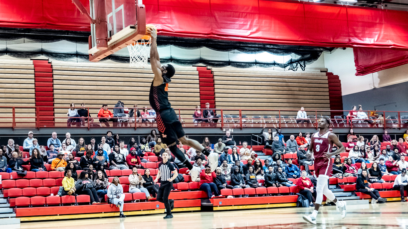 Victor Nwagbaraocha rises and dunks the ball as the crowd looks on intently against Indianapolis