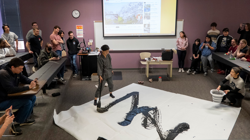 UMSL community brushes up on Japanese calligraphy at National Foreign Language Week performance