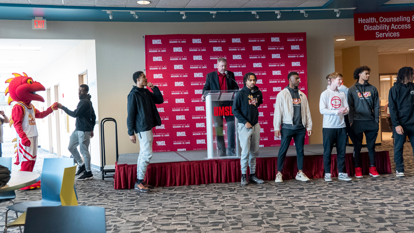 Assistant Athletic Director Luke Rinne introduces member's of the men's basketball team outside The Nosh