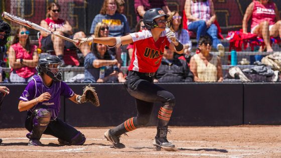 Softball player Irene Travis completes her left-handed swing