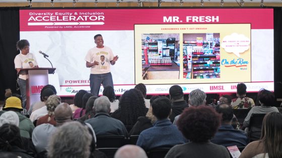 Mr. Fresh co-founder Joshua Danrich speaks on stage at DEI Accelerator Demo Day as his mom looks on