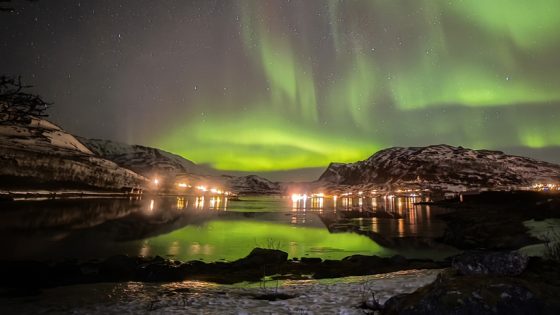 green aurora borealis over the night sky of Tromso Norway