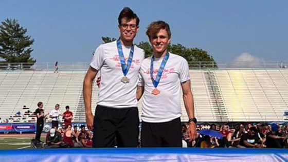 Benjamin VandenBrink and Jacob Warner stand together wearing their sBenjamin VandenBrink and Jacob Warner stand together wearing their medals after finishing second and third in the men's 5,000-meter run at Allgood-Bailey Stadium