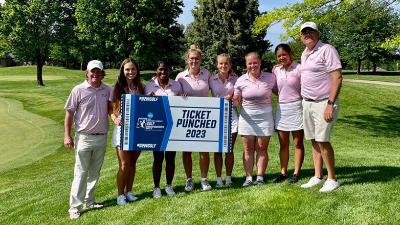 Members of the women's golf team stand together holding a sign that reads "Ticket Punched 2023" with the NCAA Division II Women's Golf Championships logo
