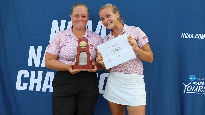 UMSL women's golfers Wilma Zanderau holds a trophy and Tove Brunell a certificate after both received All-American recognition