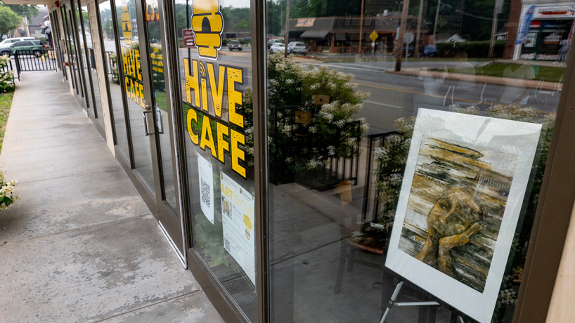 University of Missouri–St. Louis art student Abigail Lollis' "Untitled" watercolor monotype greets pedestrians as they walk past the Hive Cafe on Wednesday in downtown Ferguson, Missouri.