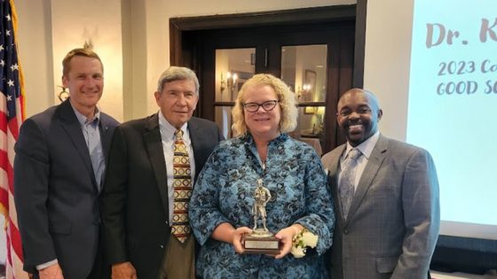 Chancellor Kristin Sobolik holds the Good Scout Award she accepted from leaders of the Boy Scouts of America's Greater St. Louis Area Council