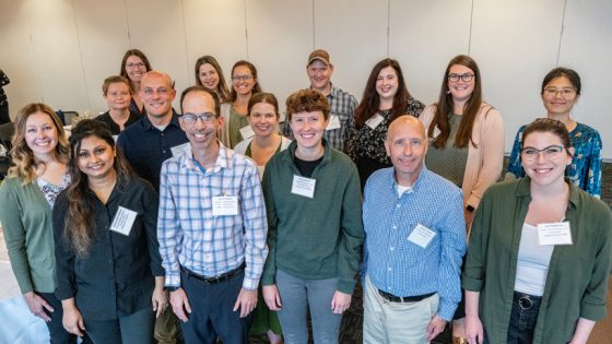 New faculty members stand together at orientation