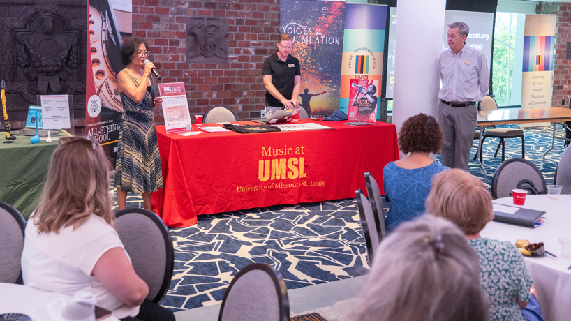UMSL Professor Joanna Mendoza talks at the Des Lee Fine Arts Education Collaborative Kickoff as colleagues Dave Wacyk and Michael Smith watch