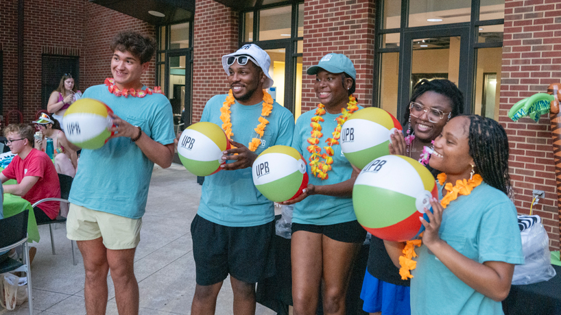Students show off their beach balls at the Oak Hall Pool Party