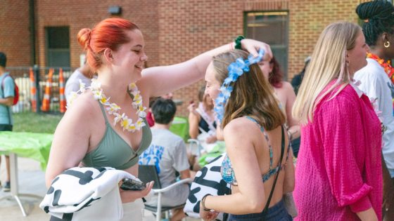 A student receives a lei at the Oak Hall Pool Party