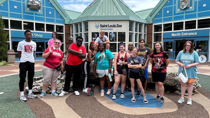 Students stand in front of the north entrance to the Saint Louis Zoo
