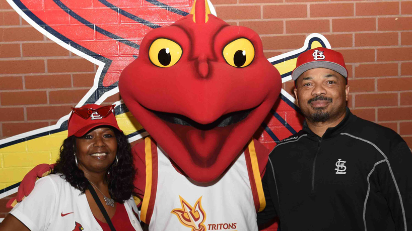 Louis takes photos with two fans at UMSL Night at the Ballpark