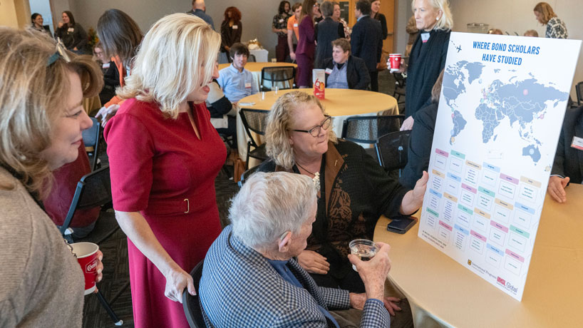 Chancellor Kristin Sobolik and former Gov. and Sen. Christopher "Kit" Bond look at a map showing where more than 60 Bond International Scholars have studied aboard since the program was launched in 2018