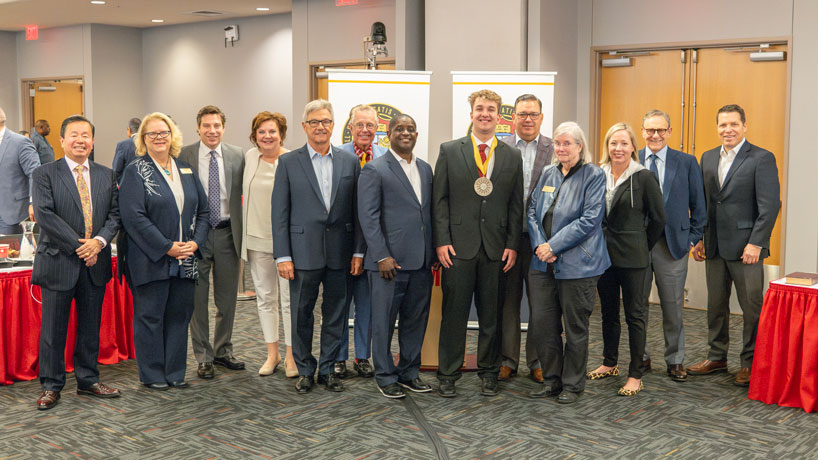 Members of the University of Missouri Board of Curators stand with UMSL student Alexander Entwistle after presenting him with the Remington R. Williams Award