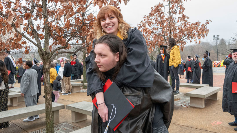 A graduate gets a piggyback ride