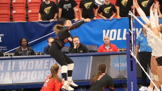 Volleyball player Lexie Rang leaps and slam the ball toward the Anderson side of the net in an NCAA Division II quarterfinal match