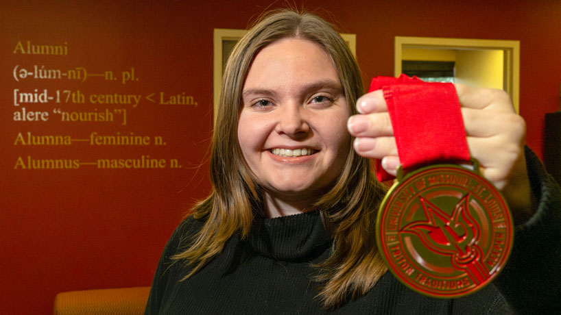 Psychology graduate Noelle Wisdom earns first Triton Traditions Keeper Medal for completing challenges in and around the UMSL campus