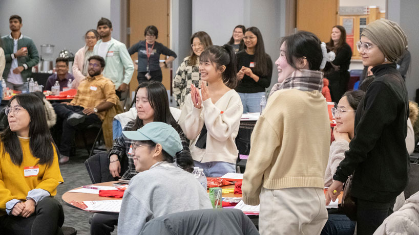 New international students share a laugh during an orientation session