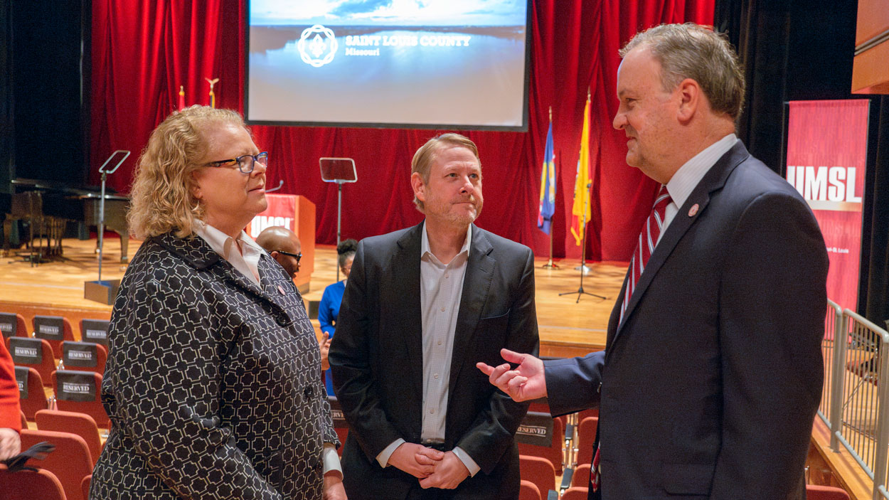 Chancellor Kristin Sobolik talks with Tim Nowak of World Trade Center St. Louis and St. Louis County Executive Dr. Sam Page before Page's State of the County Address at the Touhill