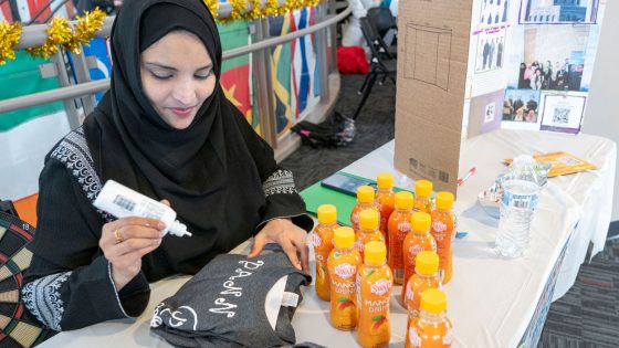 Mymoon Shaik, a senior majoring in cybersecurity and the president of the Muslim Student Association, personalizes an MSA T-shirt during the Spring Involvement Jamboree.