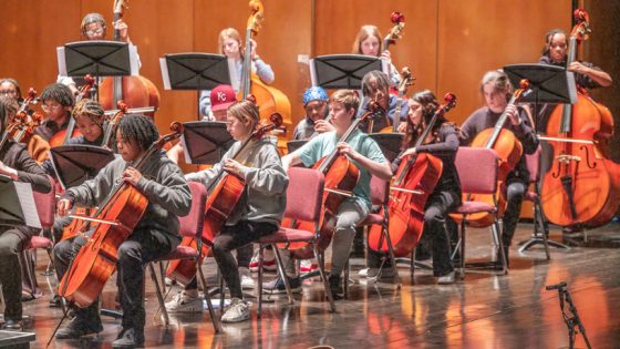 High school students playing string instruments