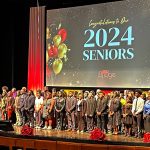 The 2024 graduating class of the UMSL Bridge Program Cigna Saturday Academy on stage at the Blanche M. Touhill Performing Arts Center