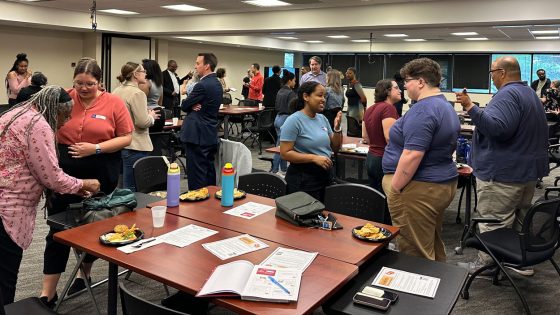 Attendees of the UMSL Forum for Community Dialogue talk one on one in an icebreaking activity at the Regional Center for Education and Work.