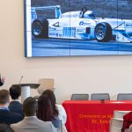 Steve Hamilton, the chairman and CEO of CSI Leasing, shares background about himself, including his love of racing, during his keynote address at the International Business Career Conference