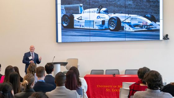 Steve Hamilton, the chairman and CEO of CSI Leasing, shares background about himself, including his love of racing, during his keynote address at the International Business Career Conference