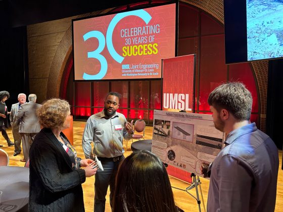 Dwayne Perry discusses his engineering design project at the JEP's 30th anniversary celebration