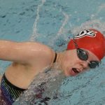 Freshman swimmer Justice Beard turns her head to take a breath during a freestyle race