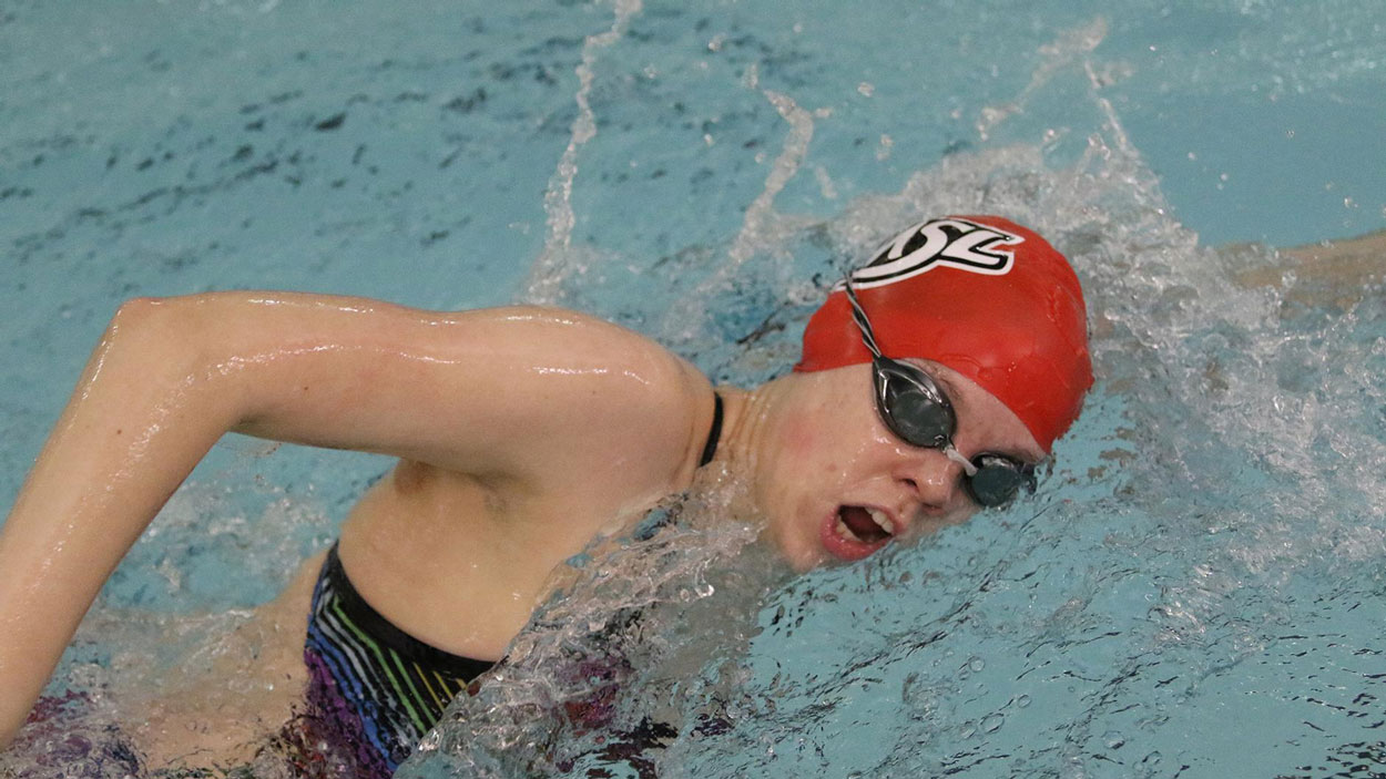 Freshman swimmer Justice Beard turns her head to take a breath during a freestyle race