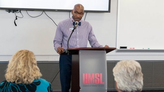 Derrick Freeman, UMSL's director of University Student Support, speaks at a lectern