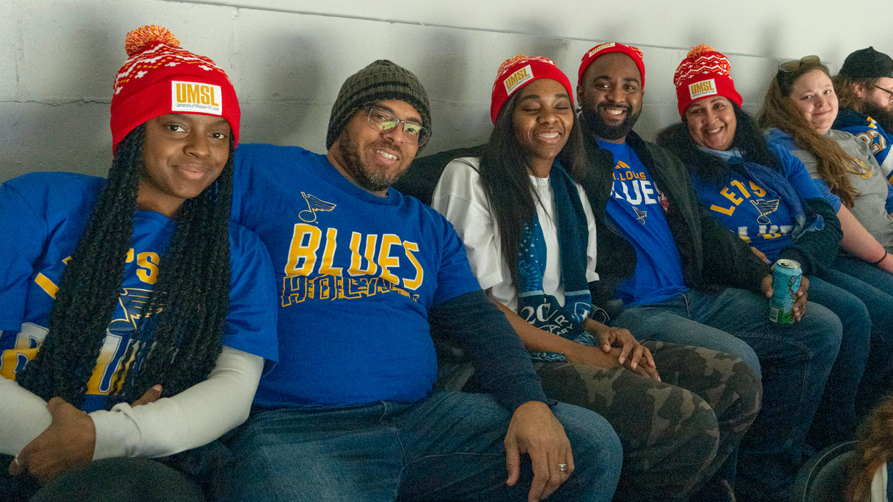 Blues fans wearing red UMSL stocking caps in their last-row seats at UMSL Night at the St. Louis Blues
