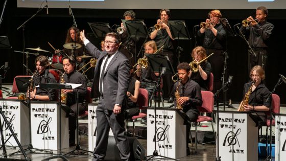 Parkway West High School Jazz Band Director Jacob England gestures toward one of the soloists during a performance as part of the Greater St. Louis Jazz Festival