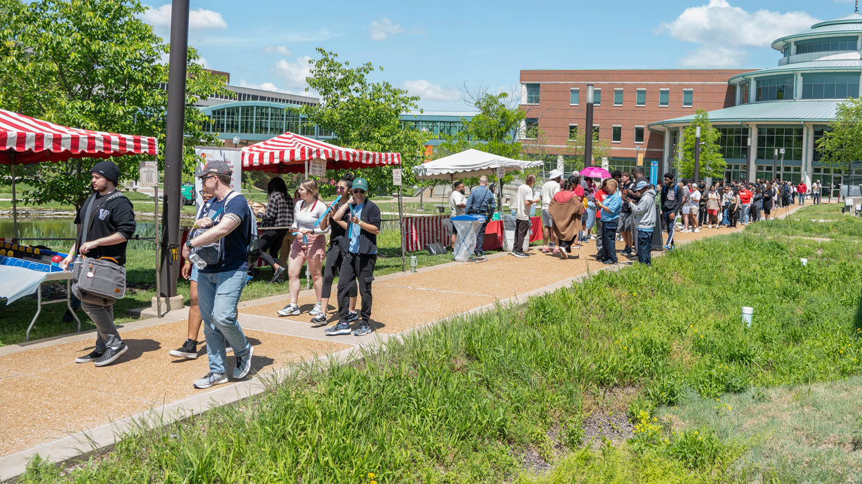 Crowds of students walk past booths outside the Millennium Student Center during the annual Mirthweek Carvinal