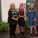 Chancellor Kristin Sobolik, Julie Packard and Aimee Dunlap standing on stage at the Robert R. Hermann World Ecology Award Gala