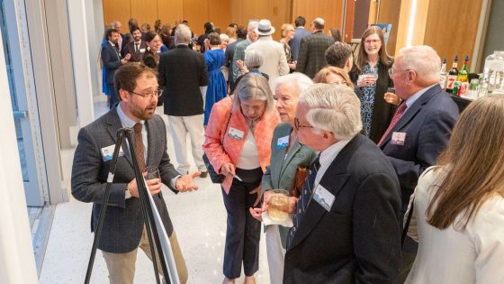UMSL doctoral student John V. Bender discusses his research with guests attending the Robert R. Hermann World Ecology Award Gala at the Missouri Botanical Garden 