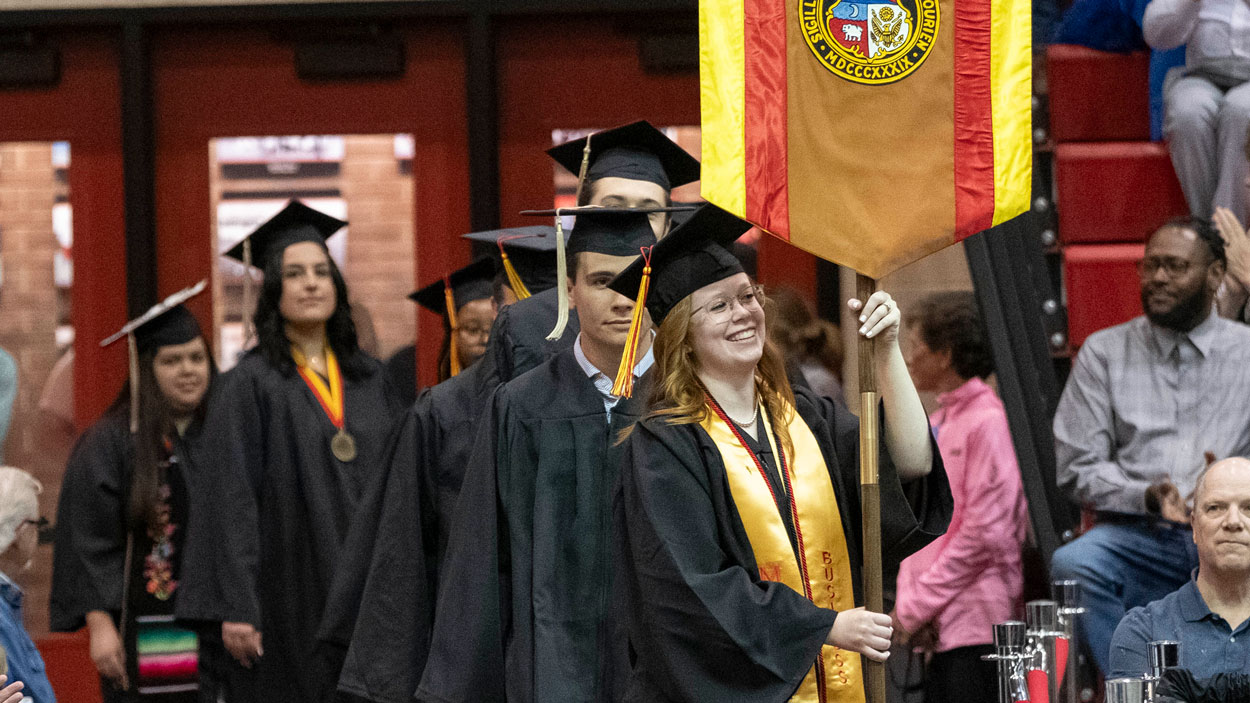 Student Marshal Angela Truesdale leads in graduates from the College of Business Administration