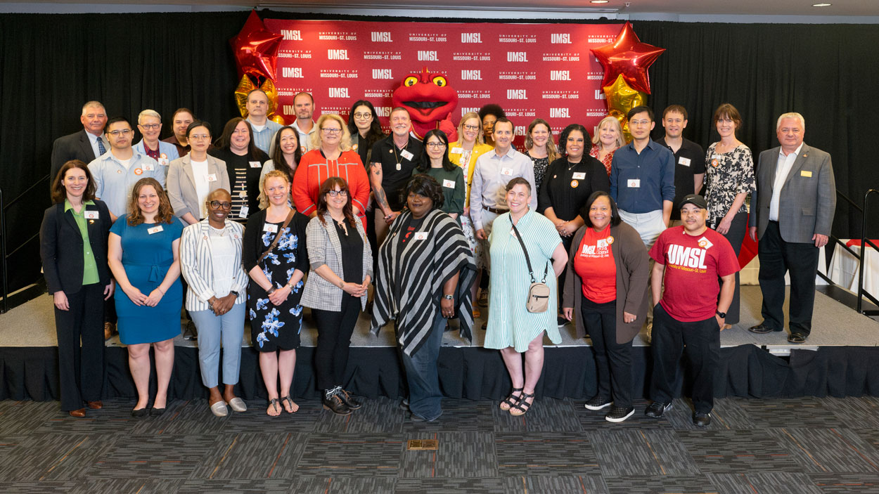 Employees marking 10 years of service at UMSL join Chancellor Kristin Sobolik, Provost Steven J. Berberich and Louie the Triton on stage during the inaugural Career Milestone Recognition Reception