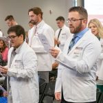Members of the University of Missouri–St. Louis College of Optometry's 2026 graduating class recite the Optometric Oath during the 25th annual White Coat Ceremony on May 17 in the Millennium Student Center
