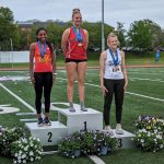 UMSL athlete Kennedy Moore stands on the second-place podium at the GLVC Outdoor Track and Field Championships